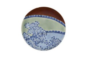 Plato. Japón, prefectura de Saga. Periodo Edo, siglo XVII. Porcelana pintada con azul cobalto bajo cubierta con esmaltes marrón hierro y verde (cerámica Arita, tipo Nabeshima). Asia Society, Nueva York: Mr. and Mrs. John D. Rockefeller 3rd Collection, 1979.248. Foto Synthescape. Cortesía de Asia Society y American Federation of Arts.